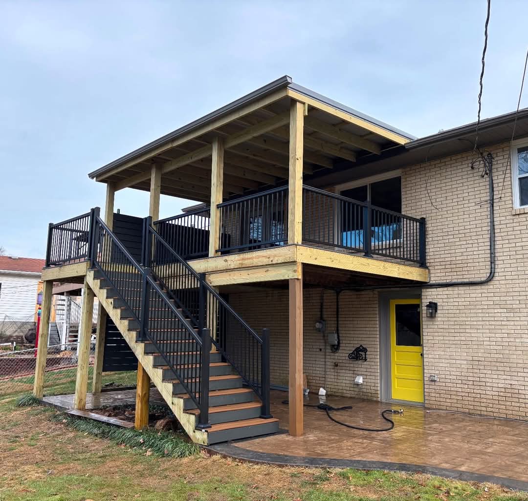Covered second-story deck with black railing built by Brothers Construction