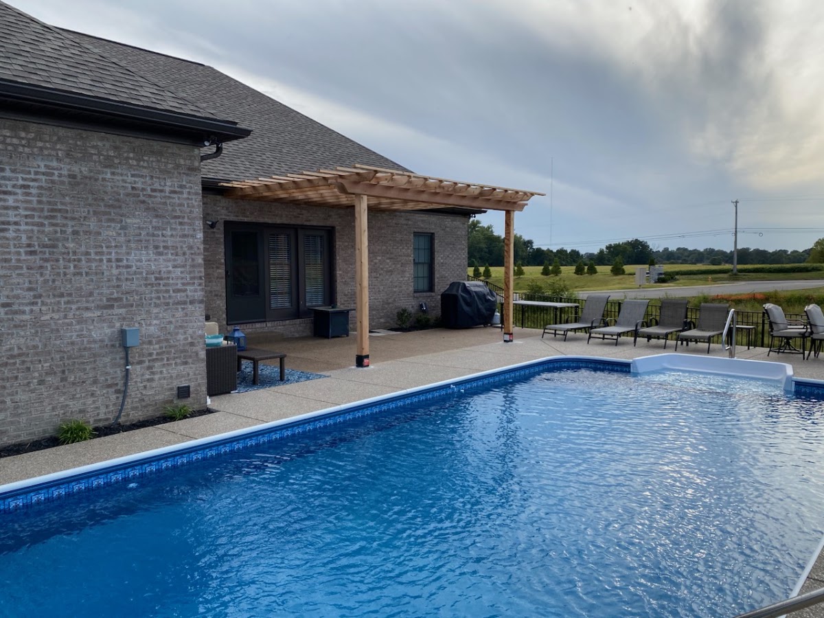 Pergola beside an inground pool